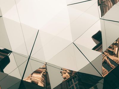 Abstract light patterns reflecting off a glass surface.