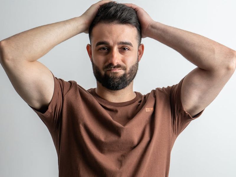 Person doing eye relaxation exercises in a bright minimalist office environment.